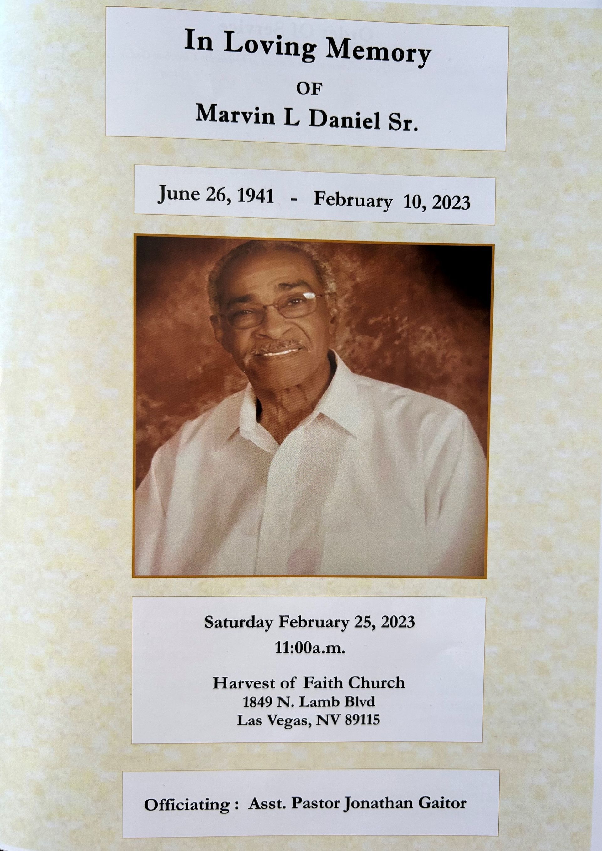 Memorial program cover with smiling portrait, “In Loving Memory Marvin L. Daniel Sr.” and funeral details