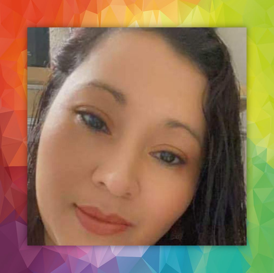 Close-up portrait of a woman with a colorful geometric background and a soft smile