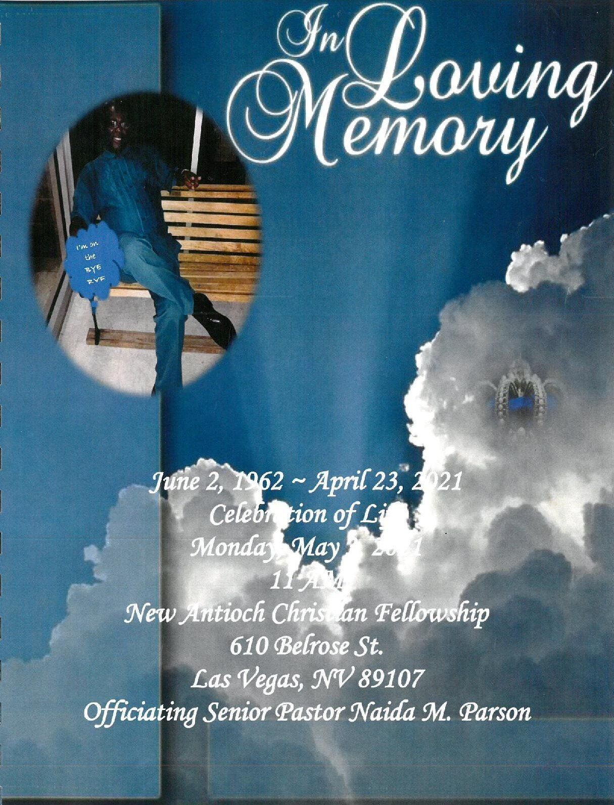 Blue memorial poster with “In Loving Memory” text and a small oval photo of a person.