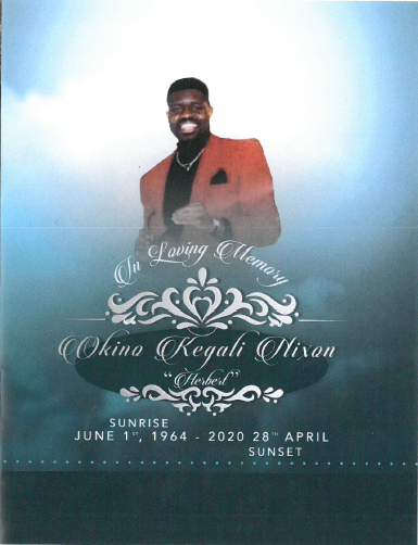 Memorial design with smiling man in red blazer above ornate white text on blue background