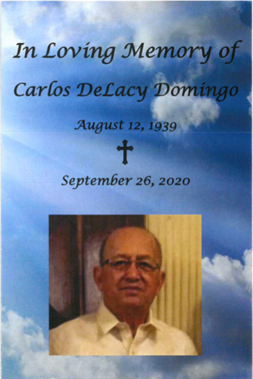 Memorial tribute with cloudy sky background, cross, dates, and portrait of Carlos Delacy Domingo