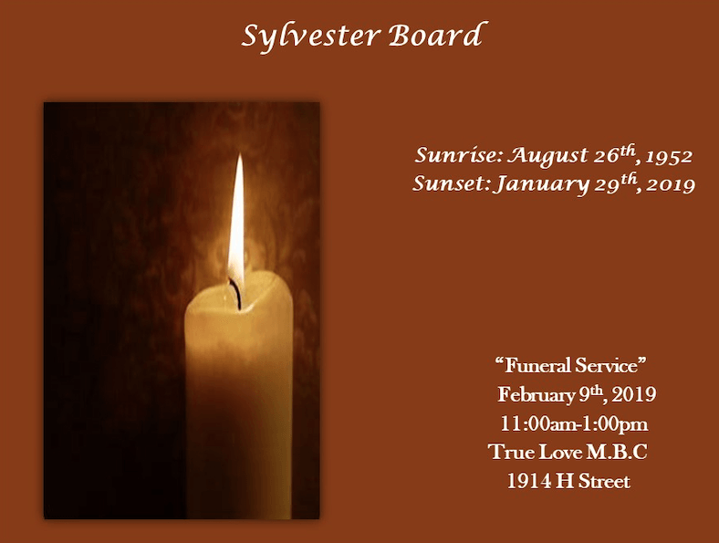 Memorial board with lit candle photo and dates: Sunrise August 26, 1952; Sunset January 29, 2019.