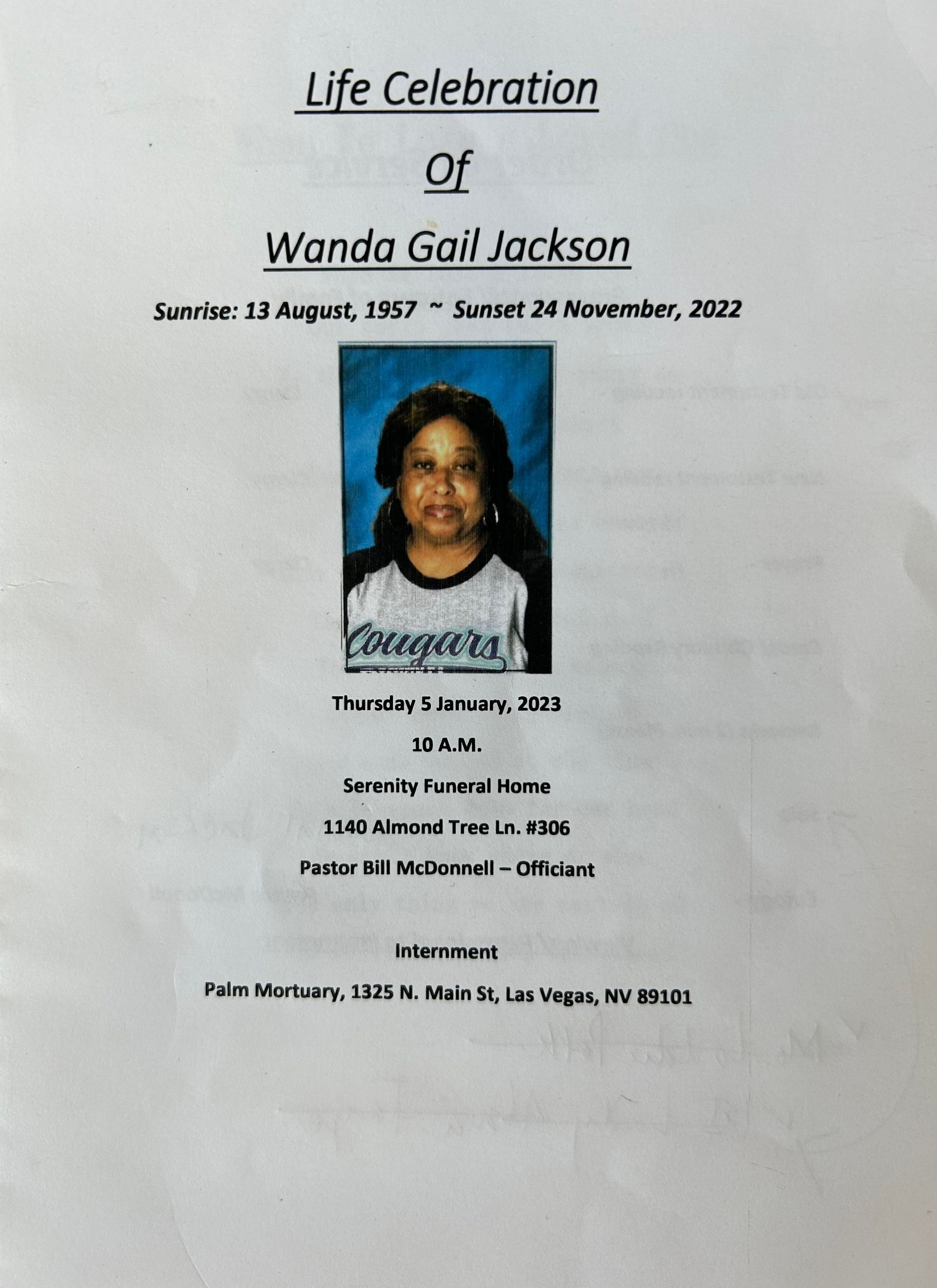 Memorial program for Wanda Gail Jackson with portrait and service details on a white page