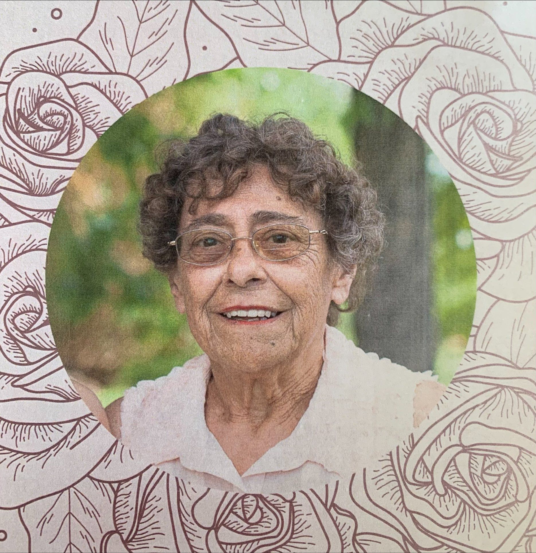 Portrait of an elderly woman smiling, framed by a circular green backdrop with floral rose patterns