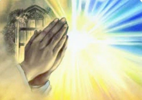 Praying hands beside a glowing bright light with blue and yellow rays