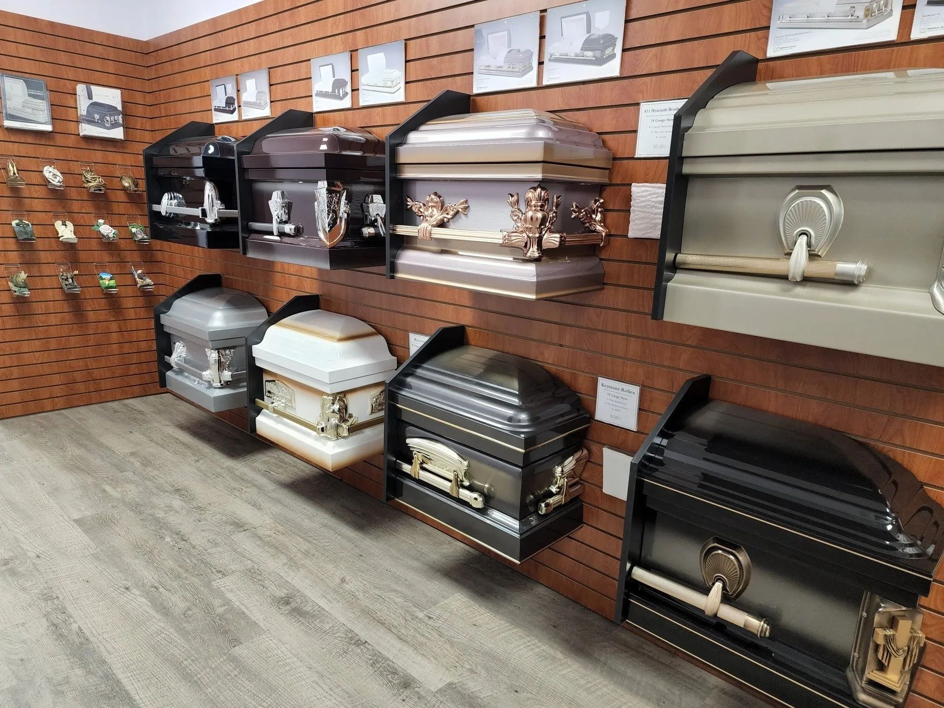 Display of decorative urns and caskets on brick walls in a showroom