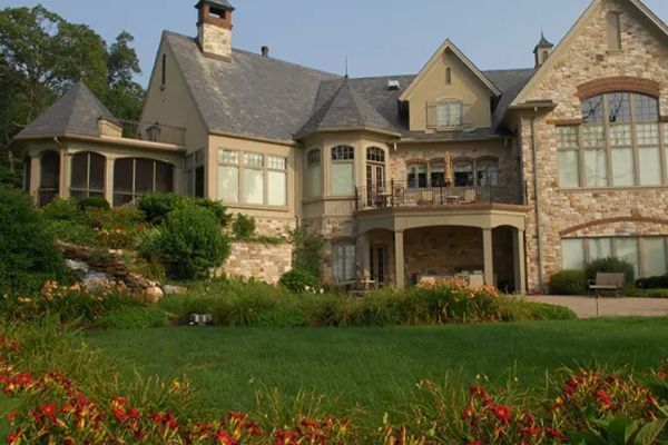 A large house with a lush green lawn in front of it