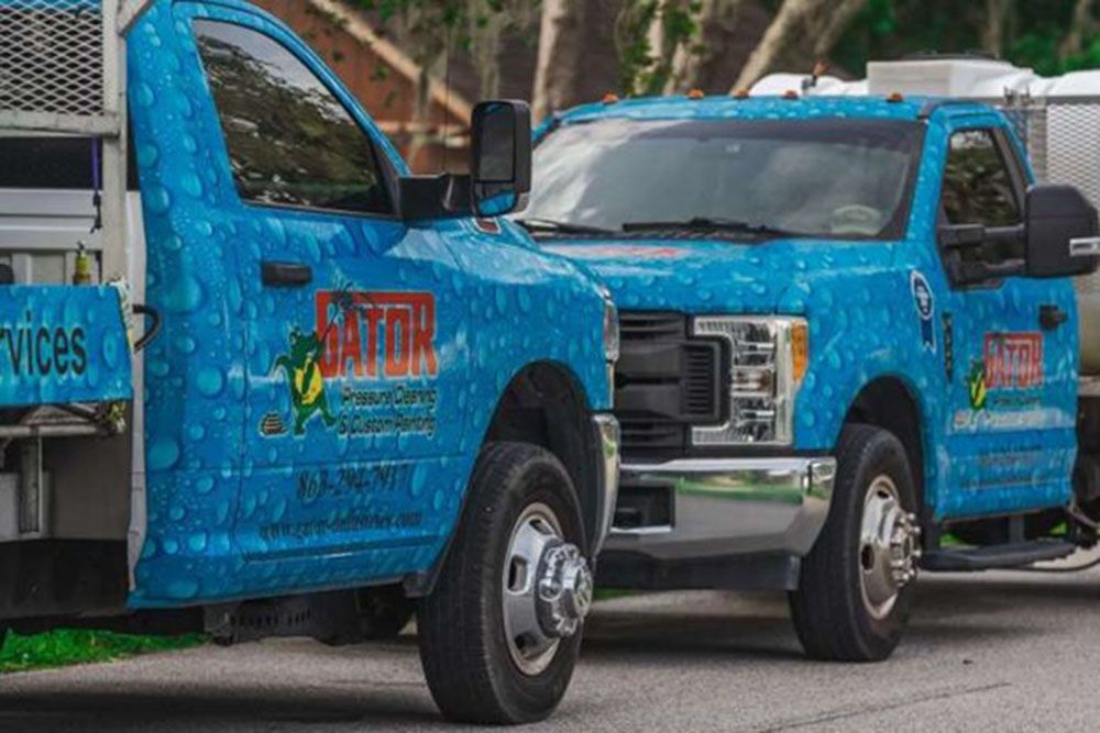 Gator Pressure Cleaning & Custom Painting Inc.'s blue trucks