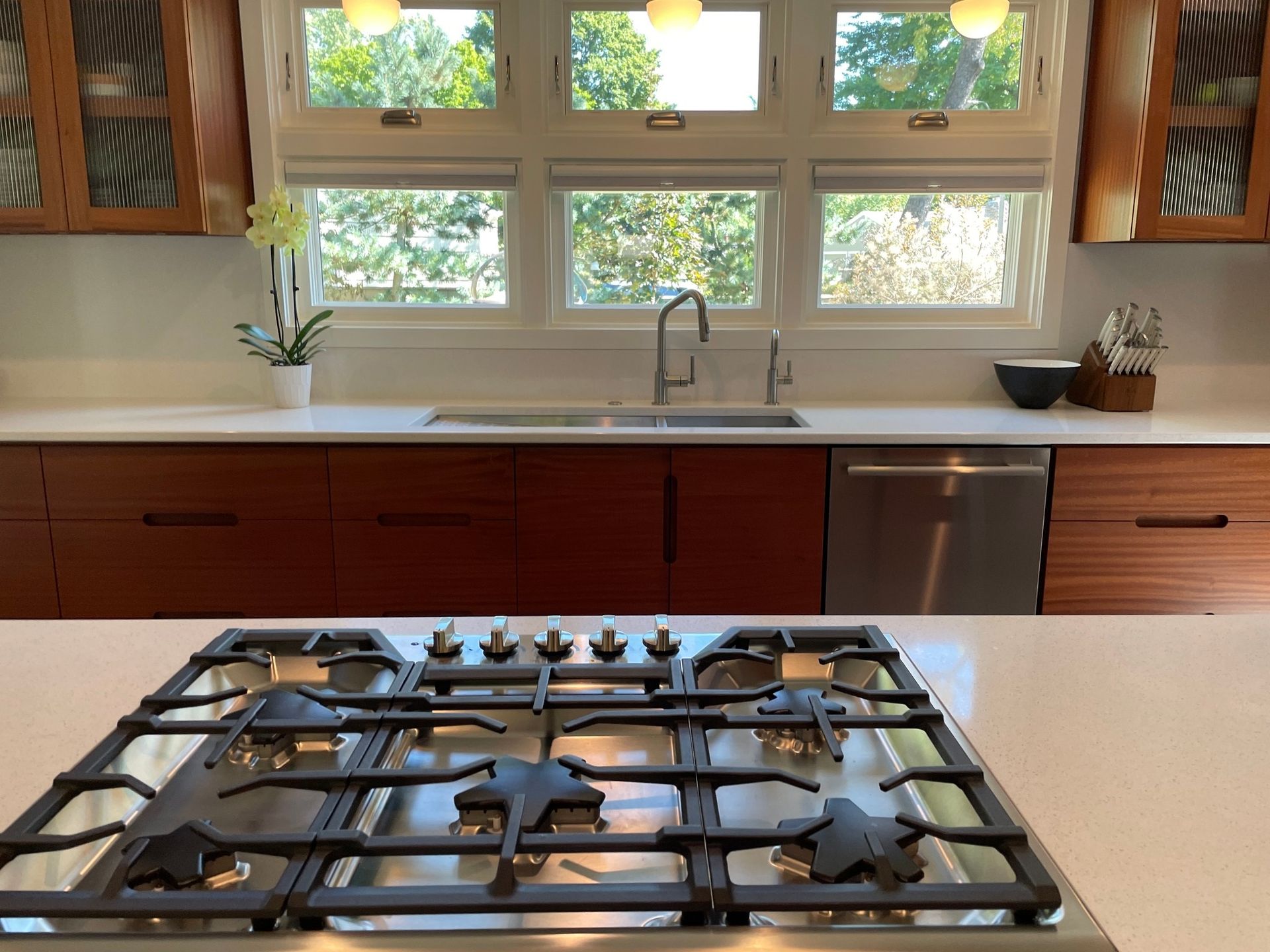 A kitchen with a stove top oven and a sink