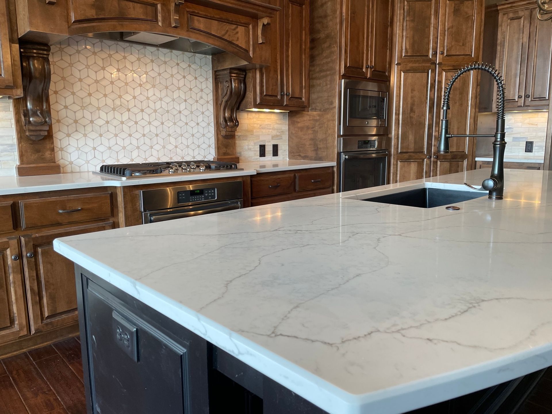 A kitchen with a large island and a sink.