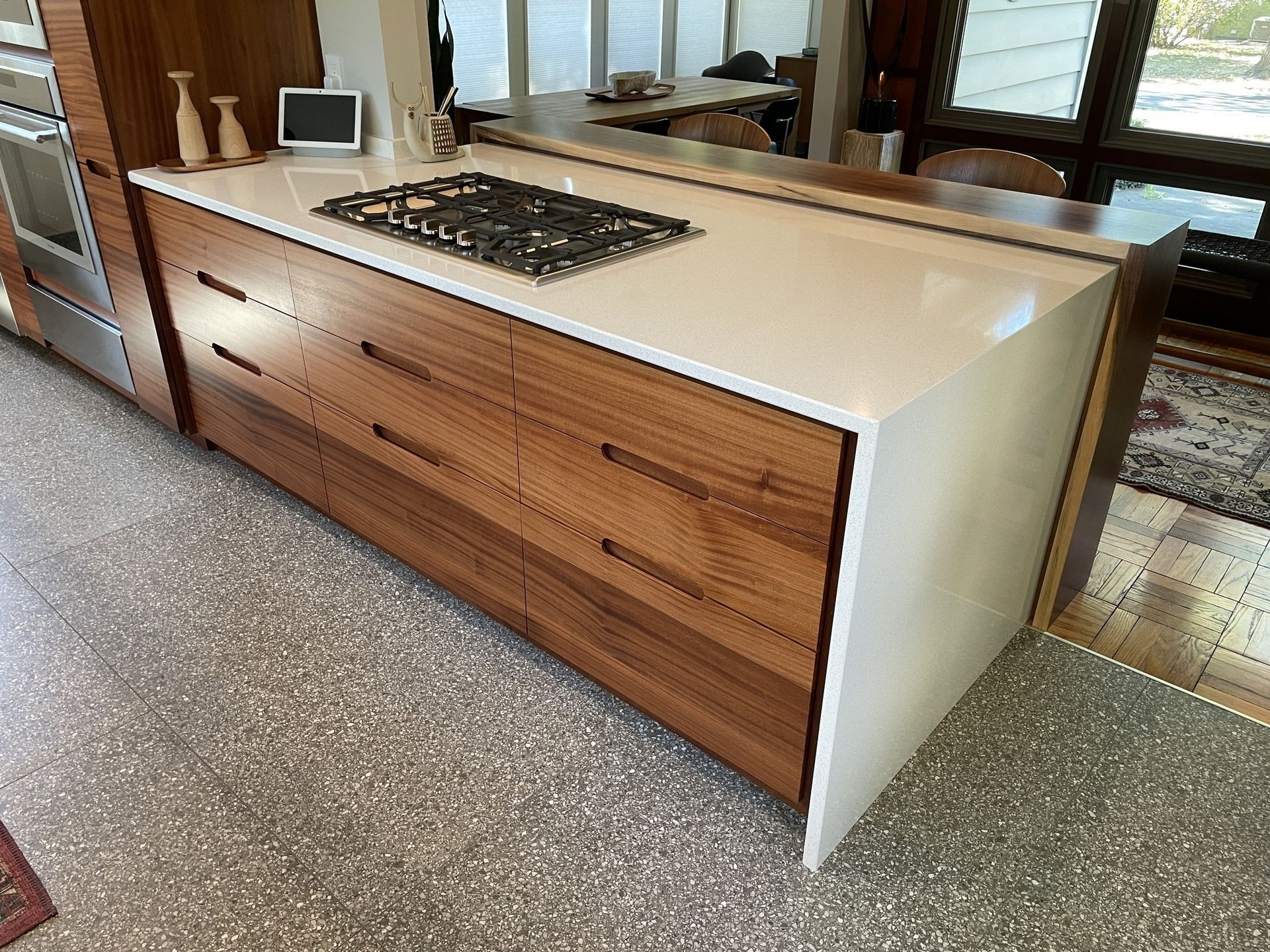 A kitchen with wooden cabinets and a stove top oven.