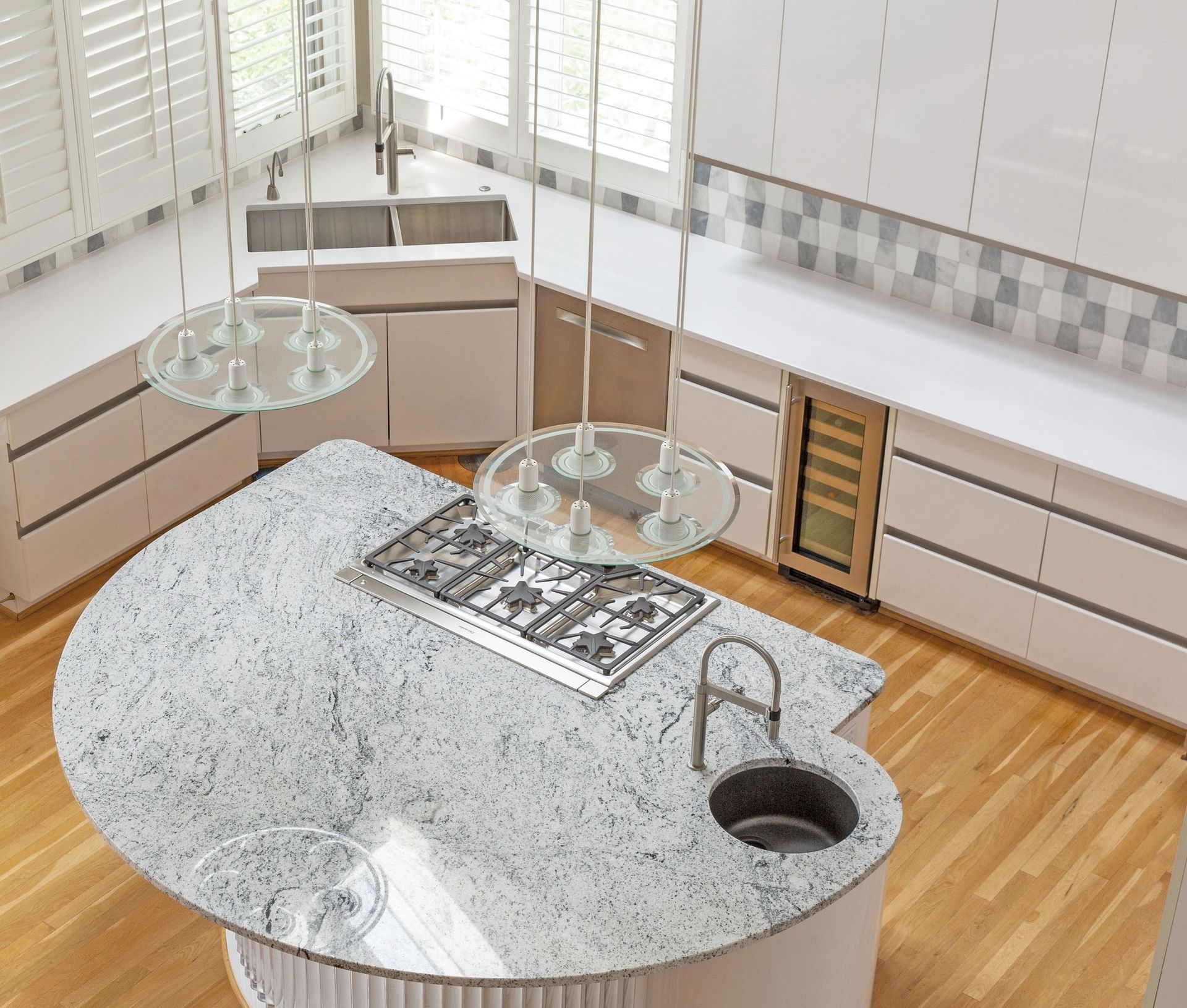 A kitchen with a stove top oven and a sink
