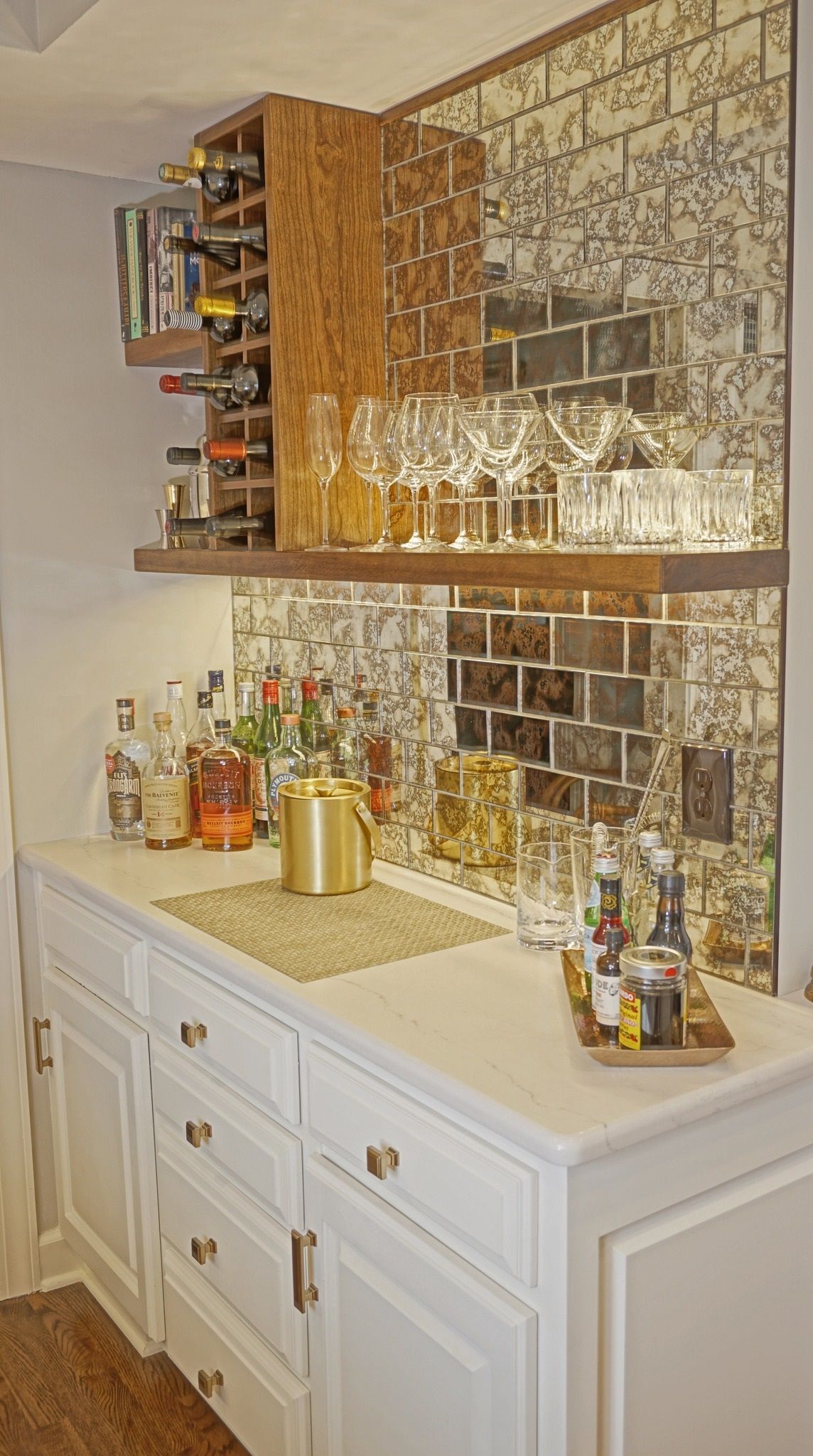 A kitchen with a bar and a wine rack.