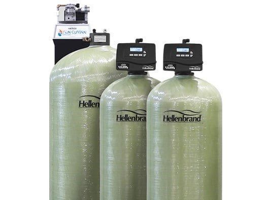 Three large, light-green Hellenbrand water filtration tanks with black control valves, set against a plain white background.