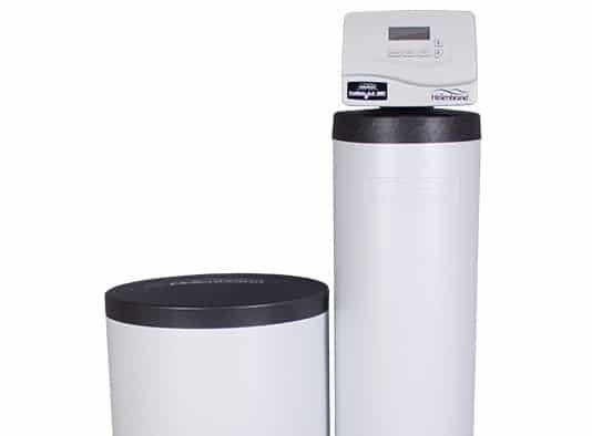 A white residential water softener system consisting of a tall resin tank with a digital control head and a brine tank.