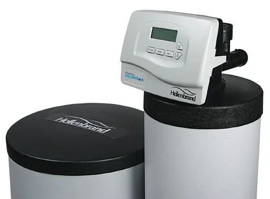 A Hellerbrand water softener system featuring a gray control head with a digital display mounted on a tall white tank.
