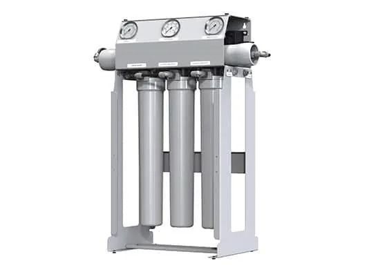 A triple-stage industrial water filtration system with three cylindrical cartridges and three pressure gauges.