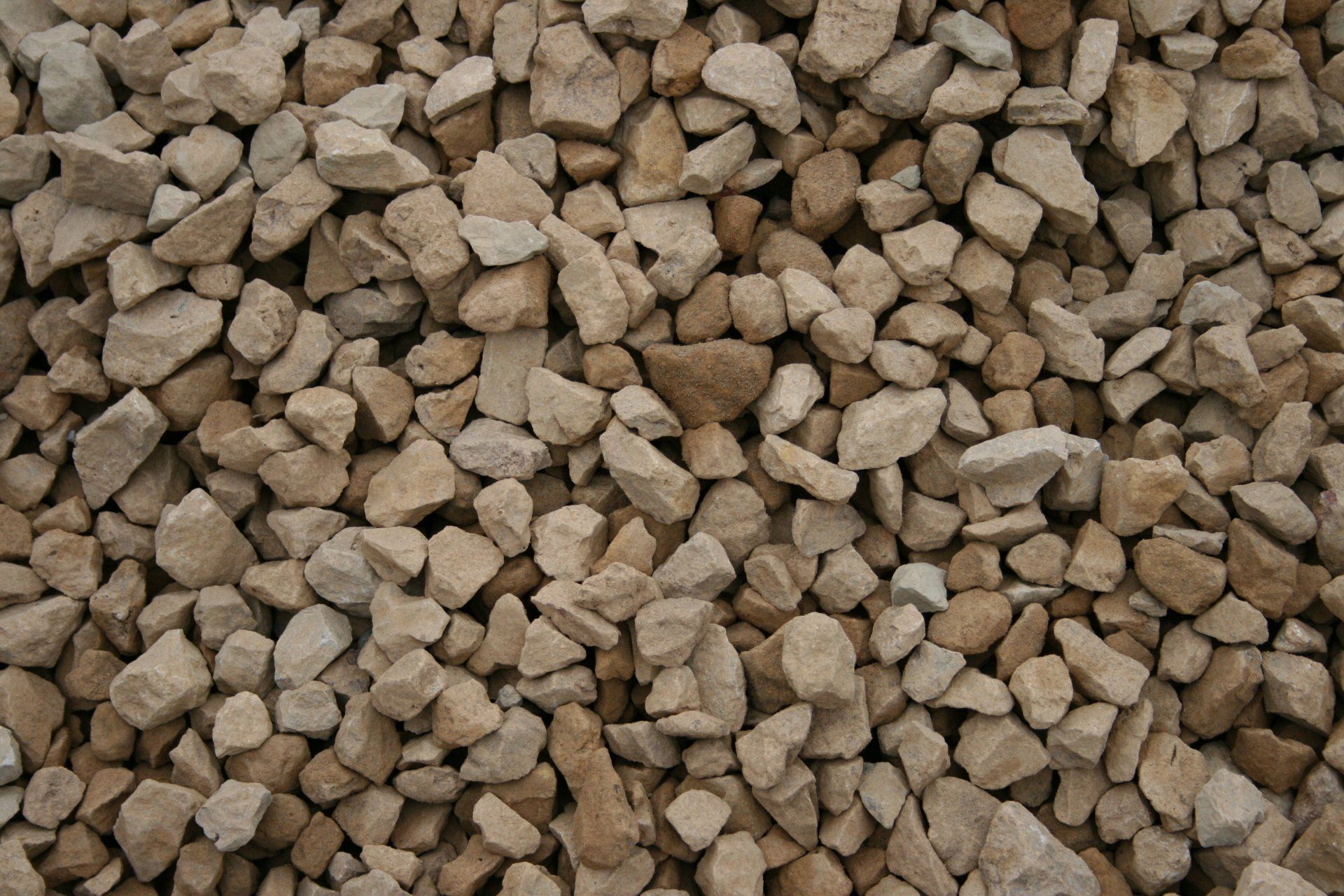 A pile of brown gravel is sitting on the ground.