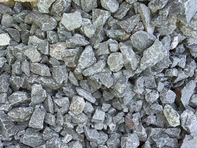 A pile of gravel is sitting on the ground.