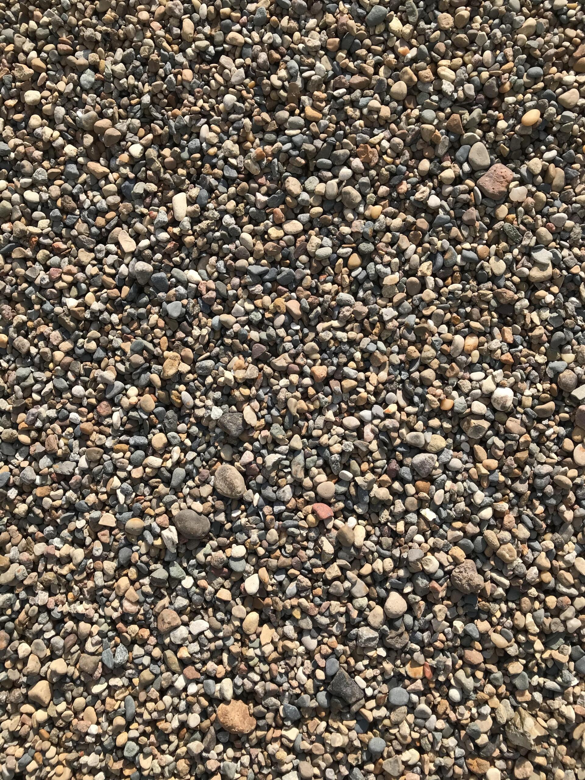 A pile of gravel is sitting on the ground.