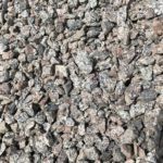 A pile of gravel is sitting on the ground.