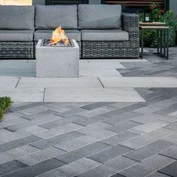 There is a fire pit in the middle of the patio.