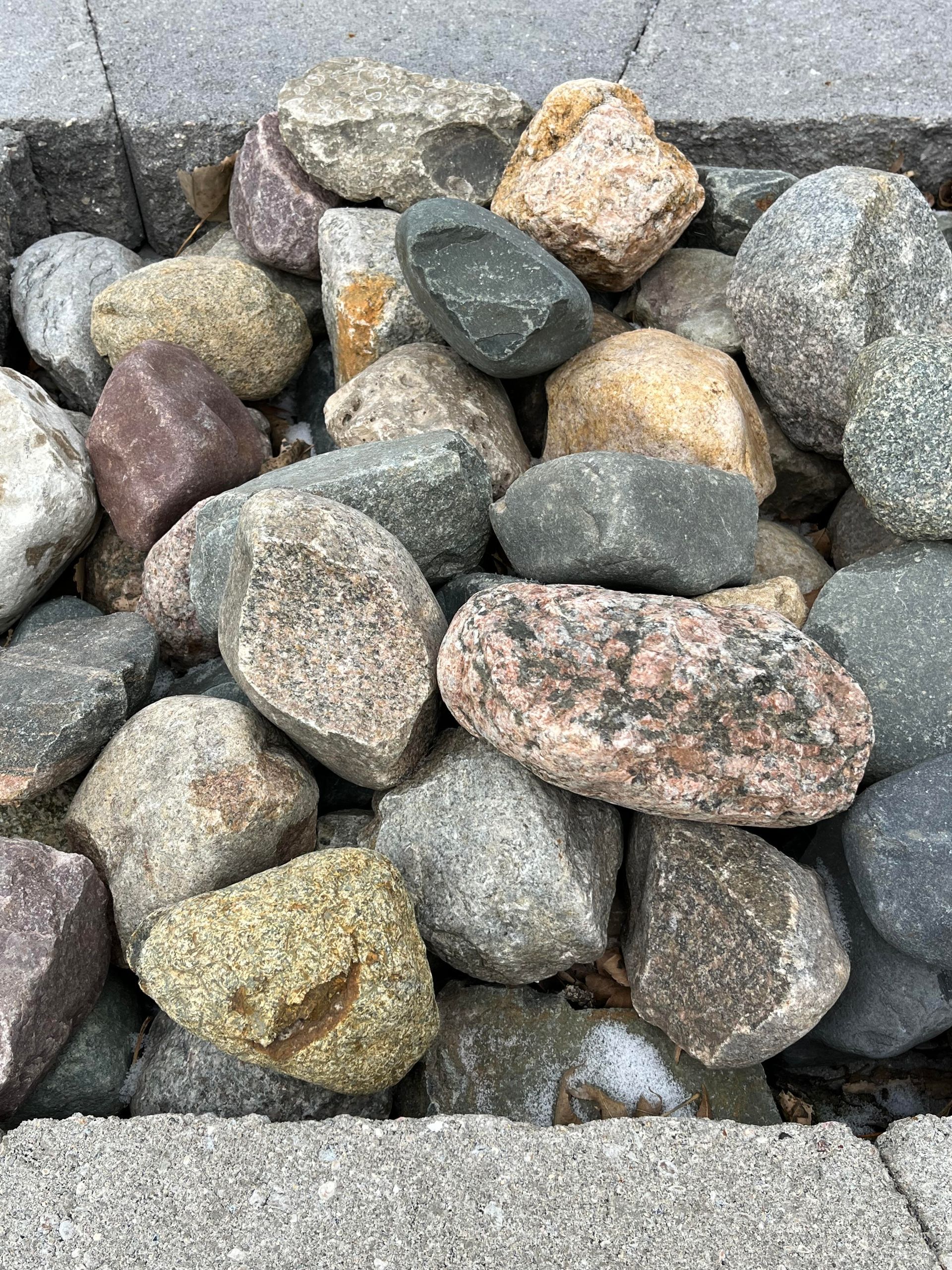 A pile of rocks sitting on top of a concrete surface.