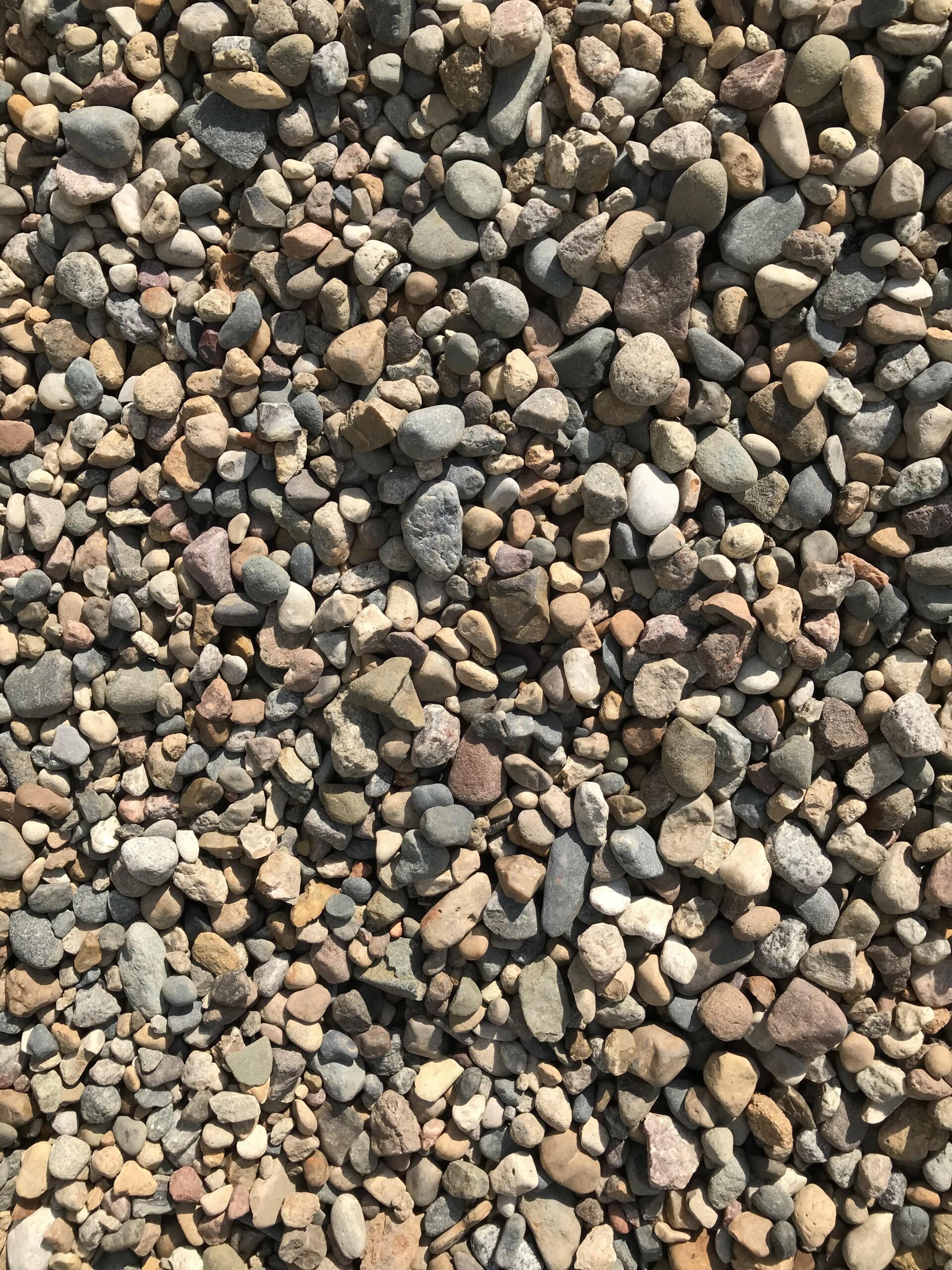 A pile of gravel is sitting on the ground.