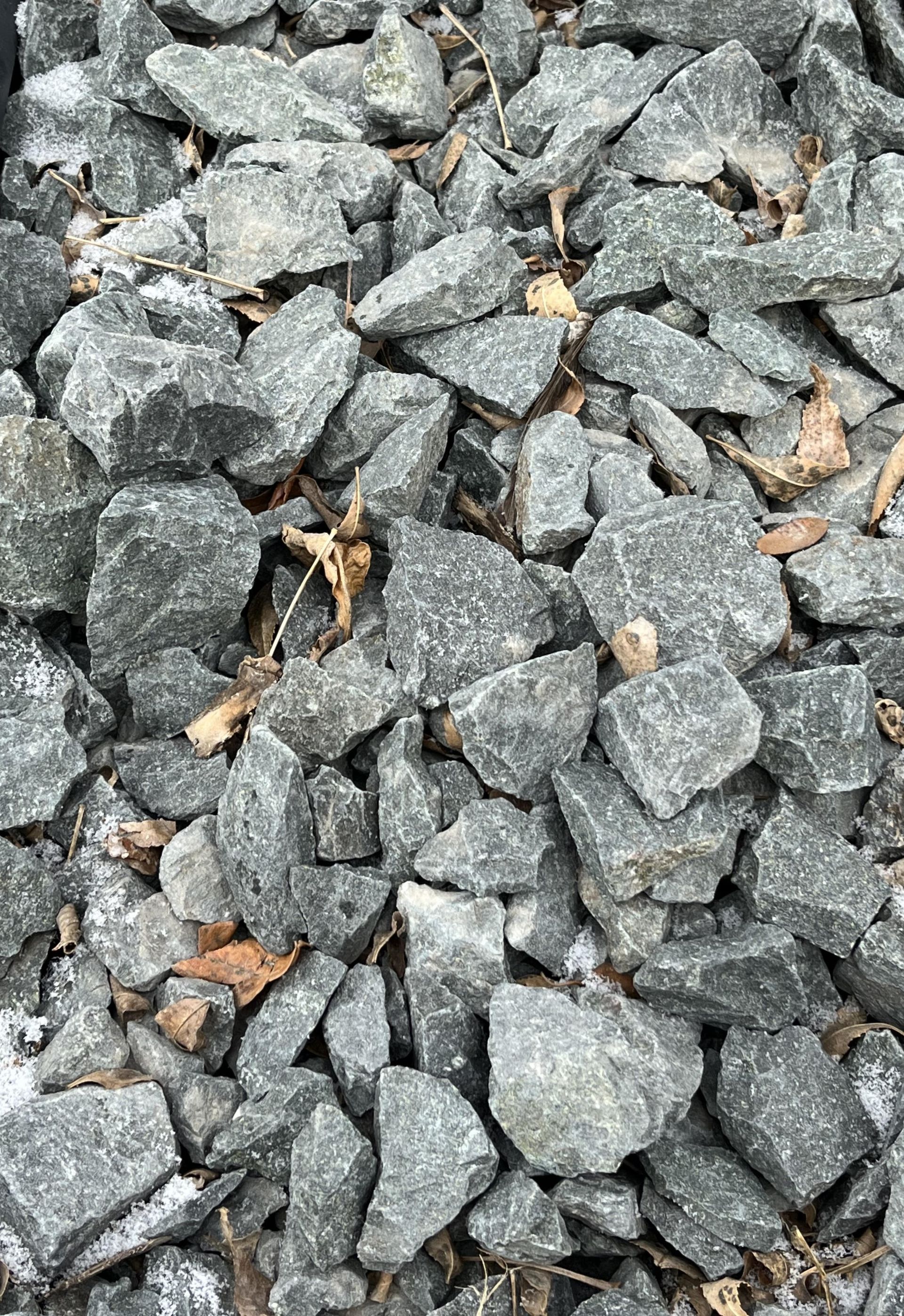 A pile of rocks is sitting on the ground.