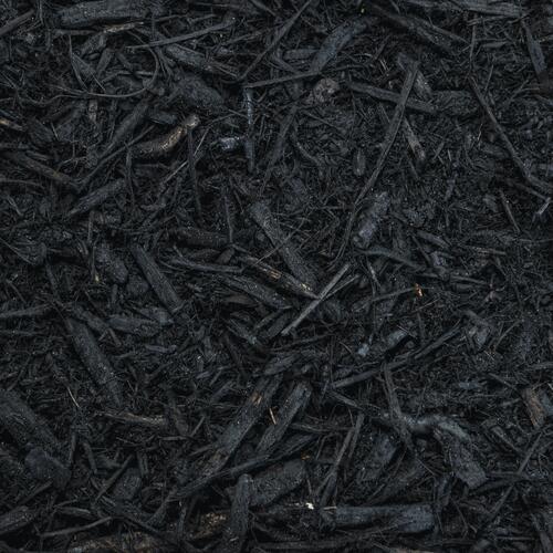A pile of black mulch is sitting on the ground.