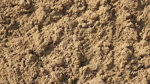 A close up of a pile of sand on a beach.