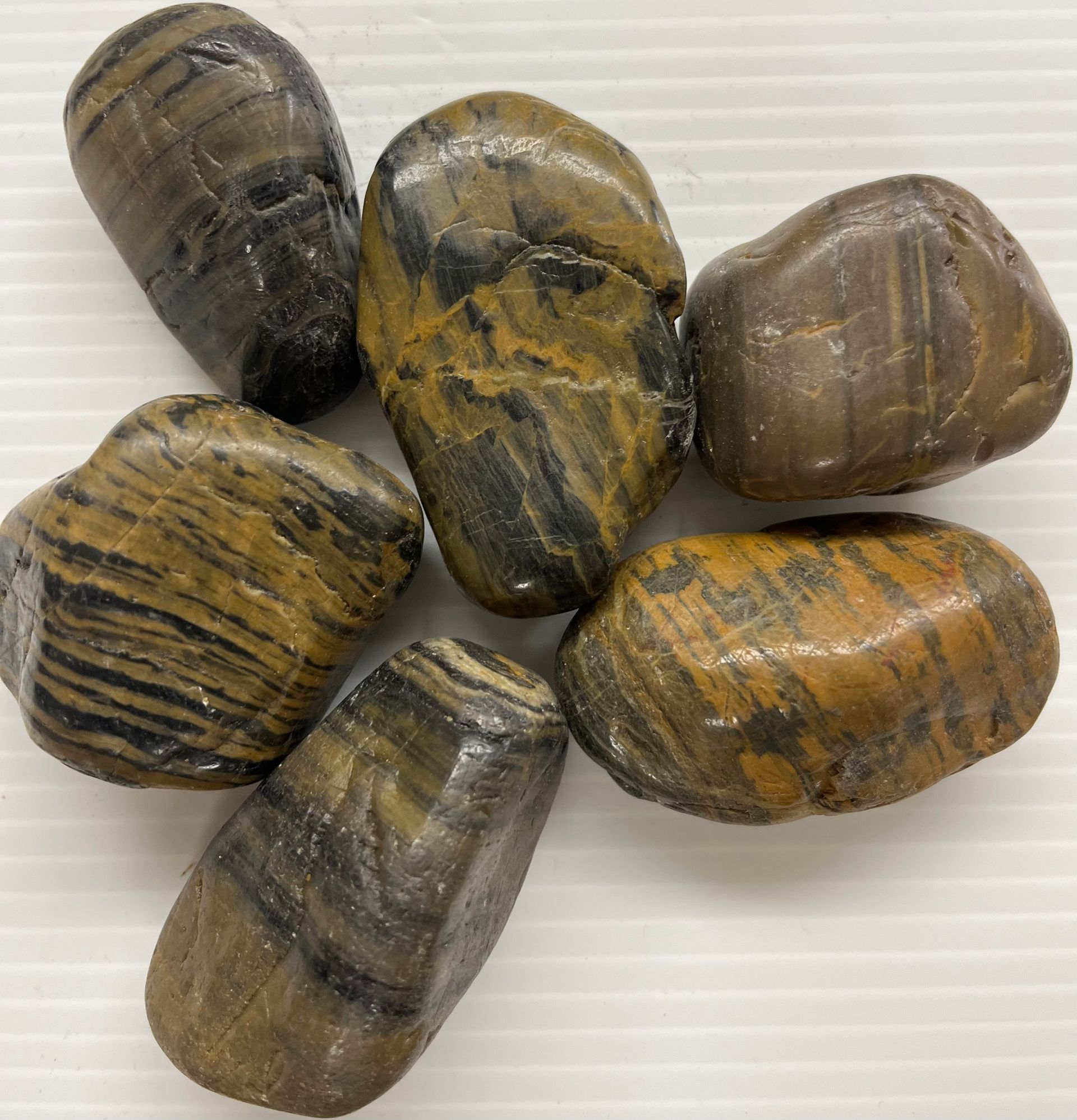 A group of rocks are sitting on top of each other on a white surface.