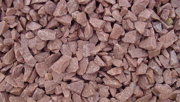 A pile of brown gravel is sitting on top of each other.