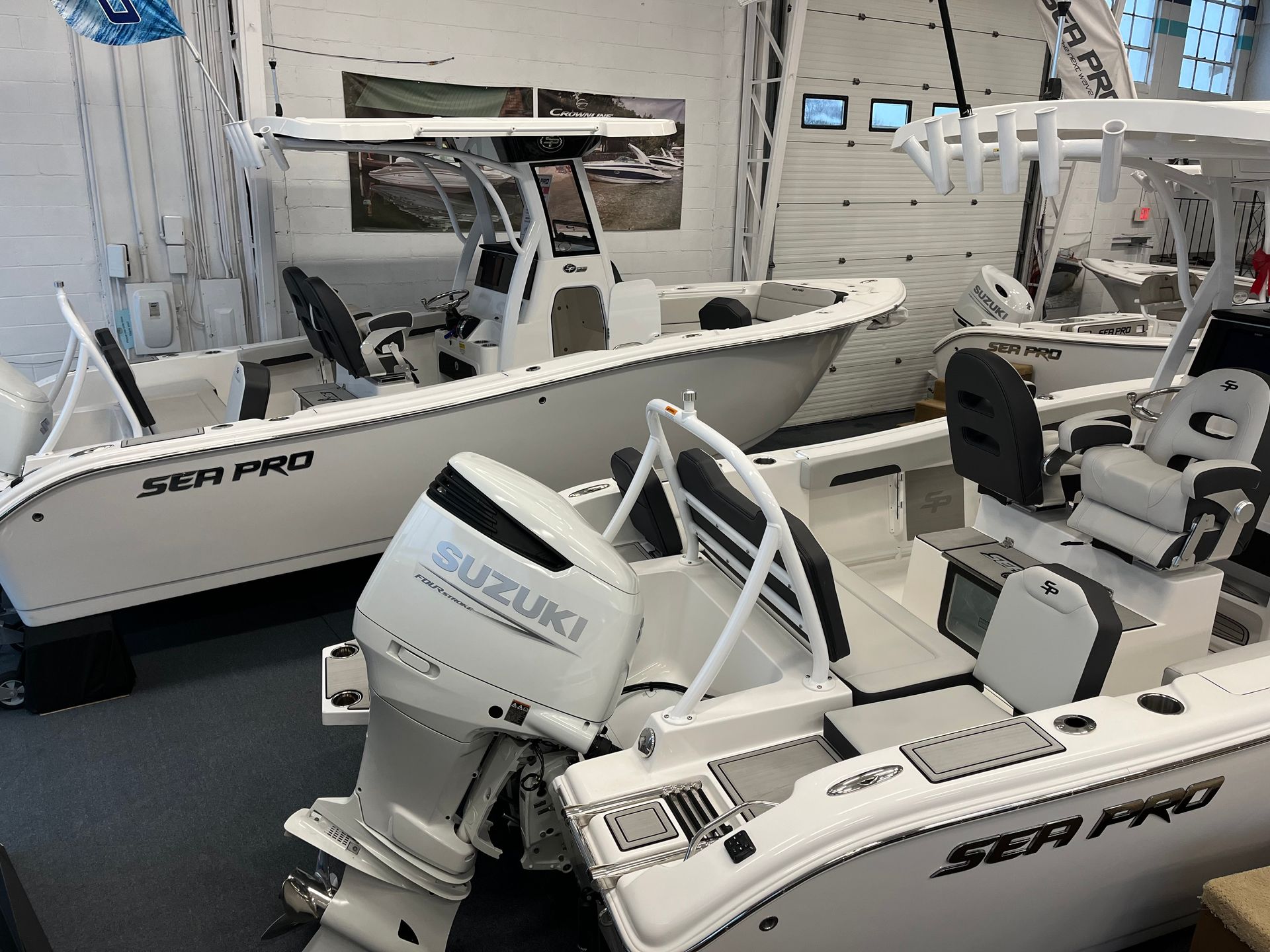 Side view of two white boats in the showroom.