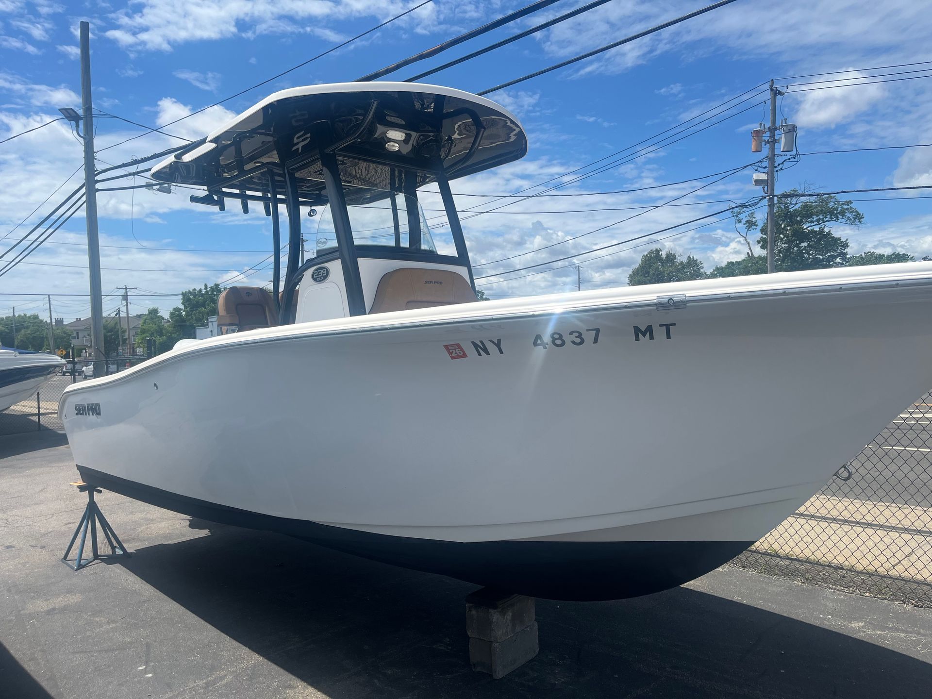 A white boat is parked on the side of the road.
