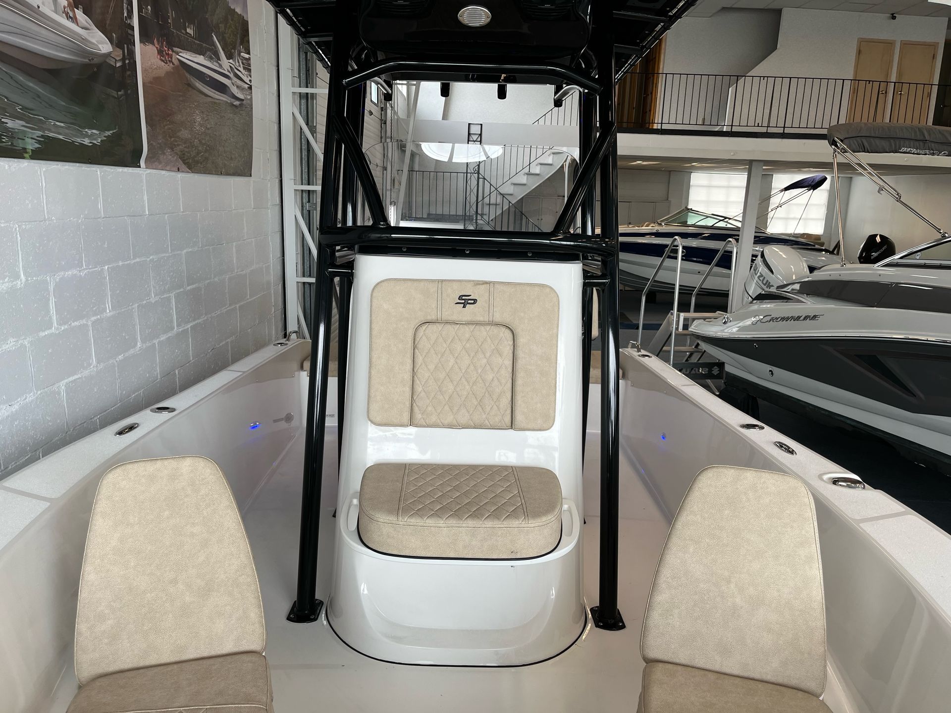 A white boat with two seats in a showroom