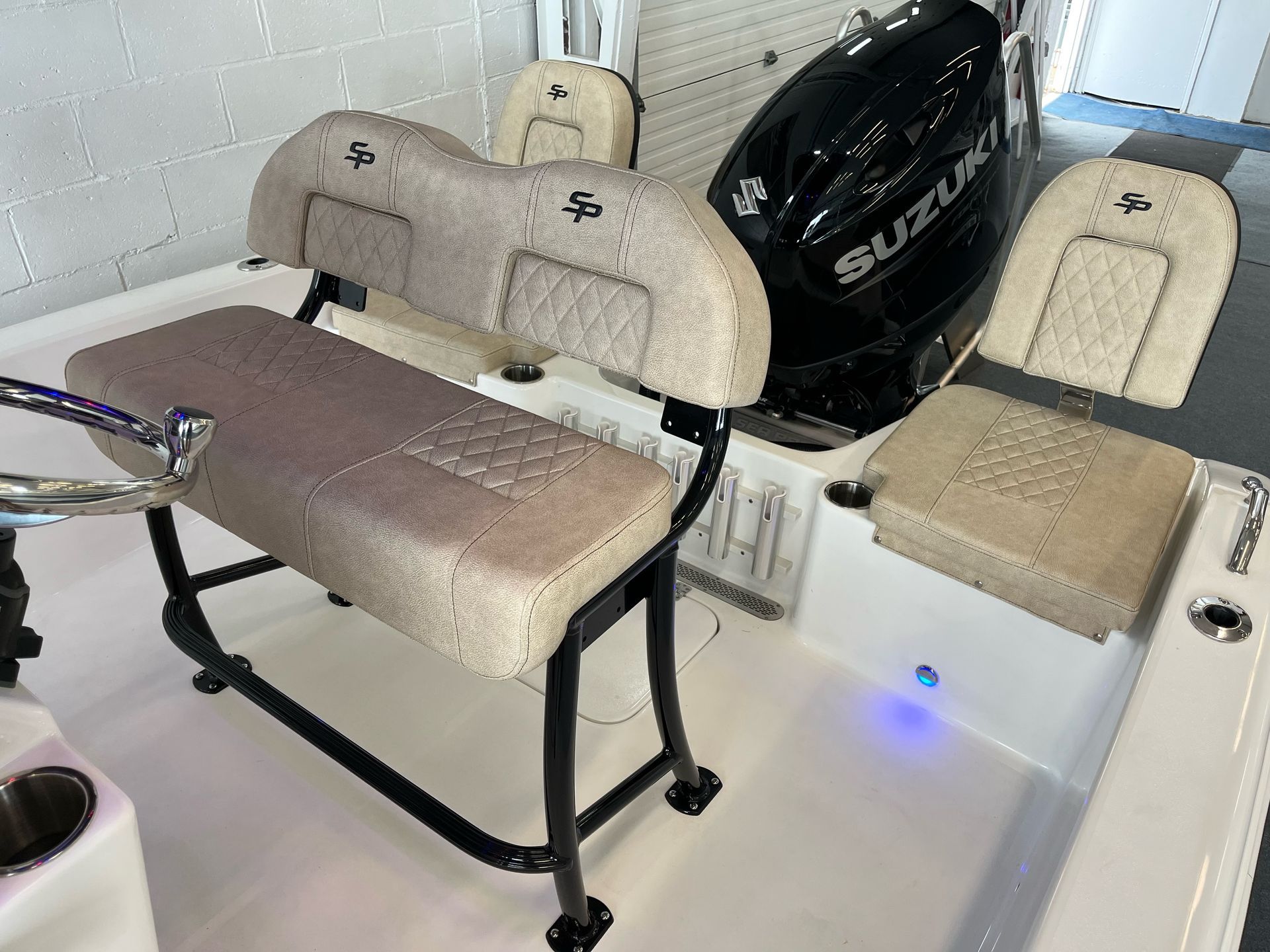 A boat with two seats and a suzuki engine