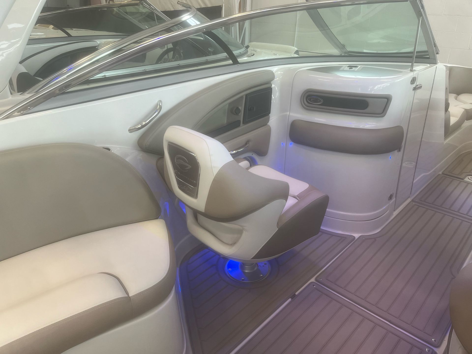 The inside of a boat with a seat and a door.