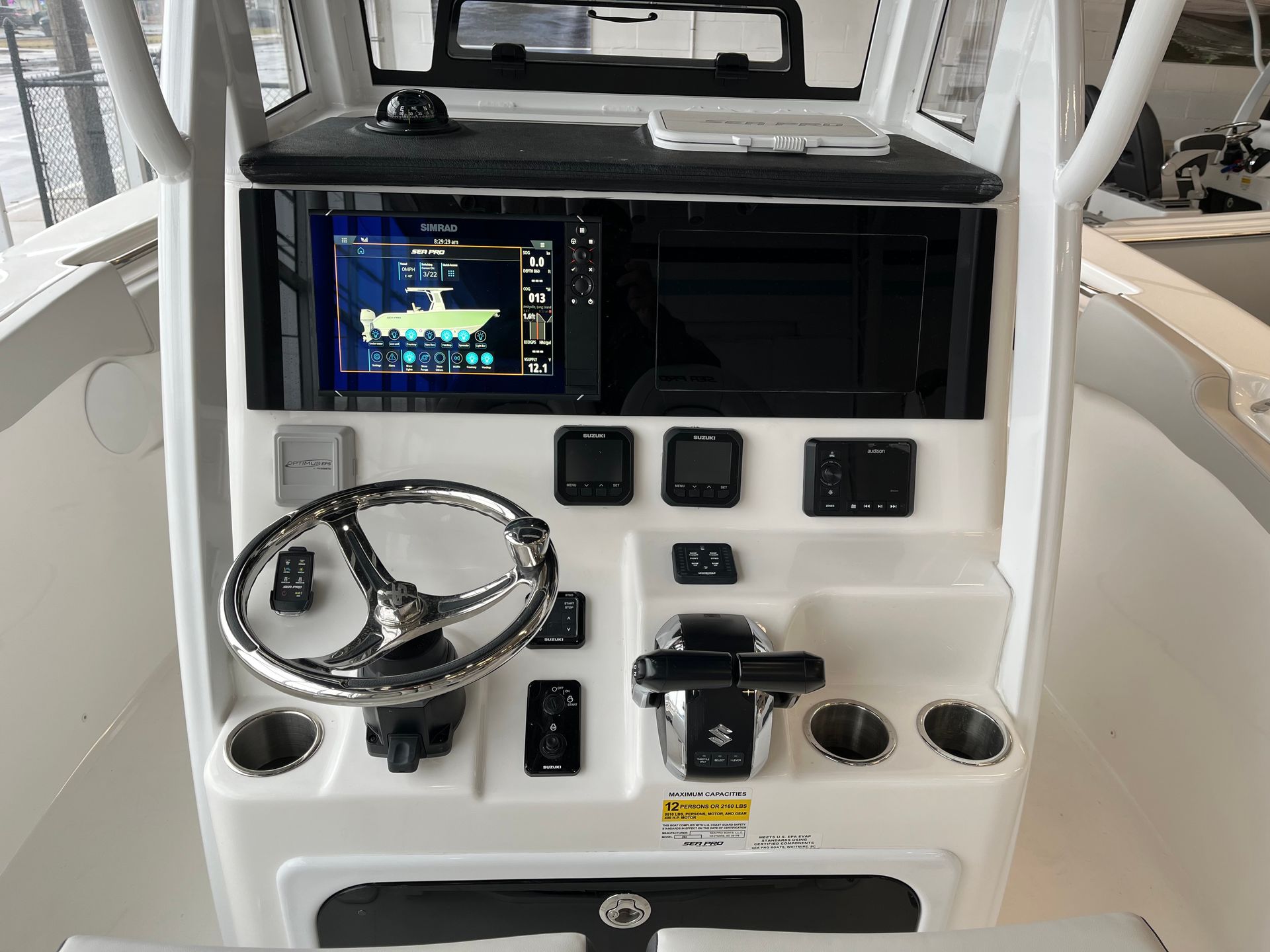 the front of the boat with steering wheel and monitor