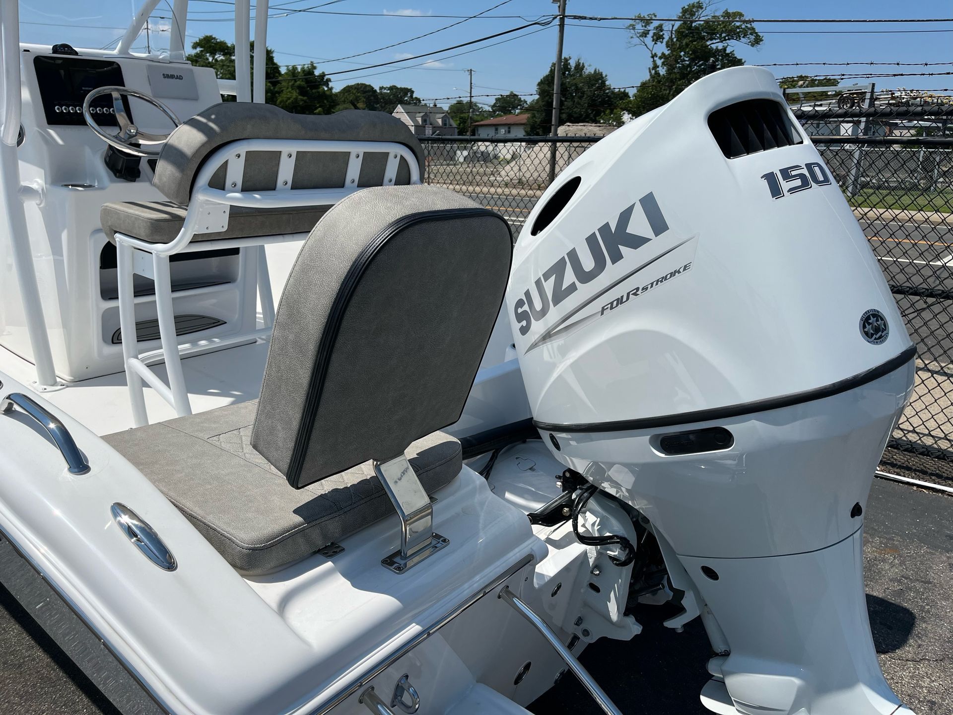 A white boat with a suzuki outboard motor