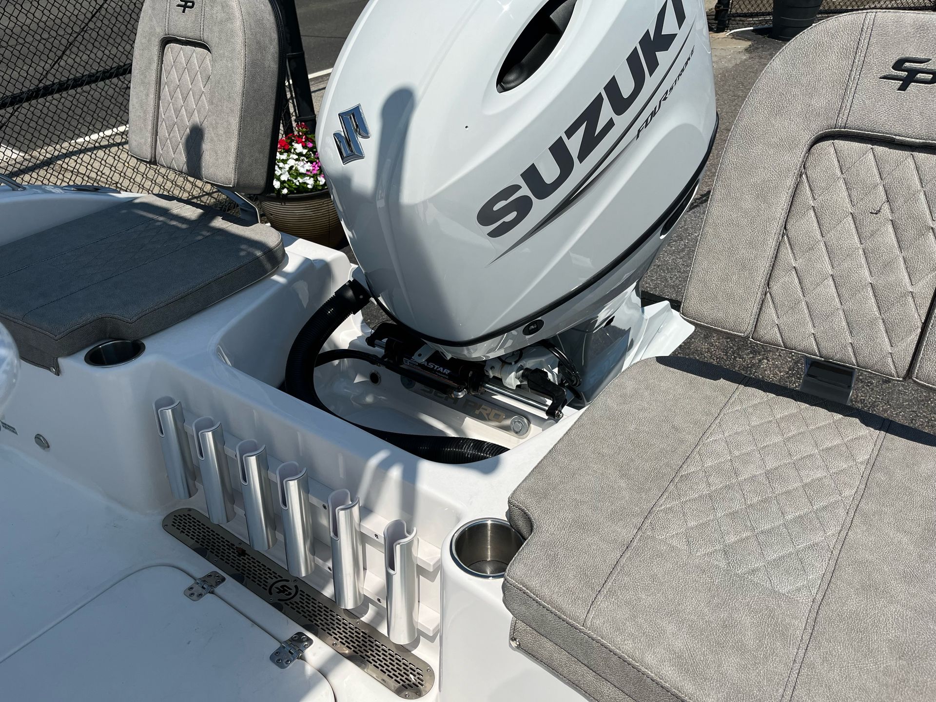 A suzuki outboard motor is sitting in the back of a boat.