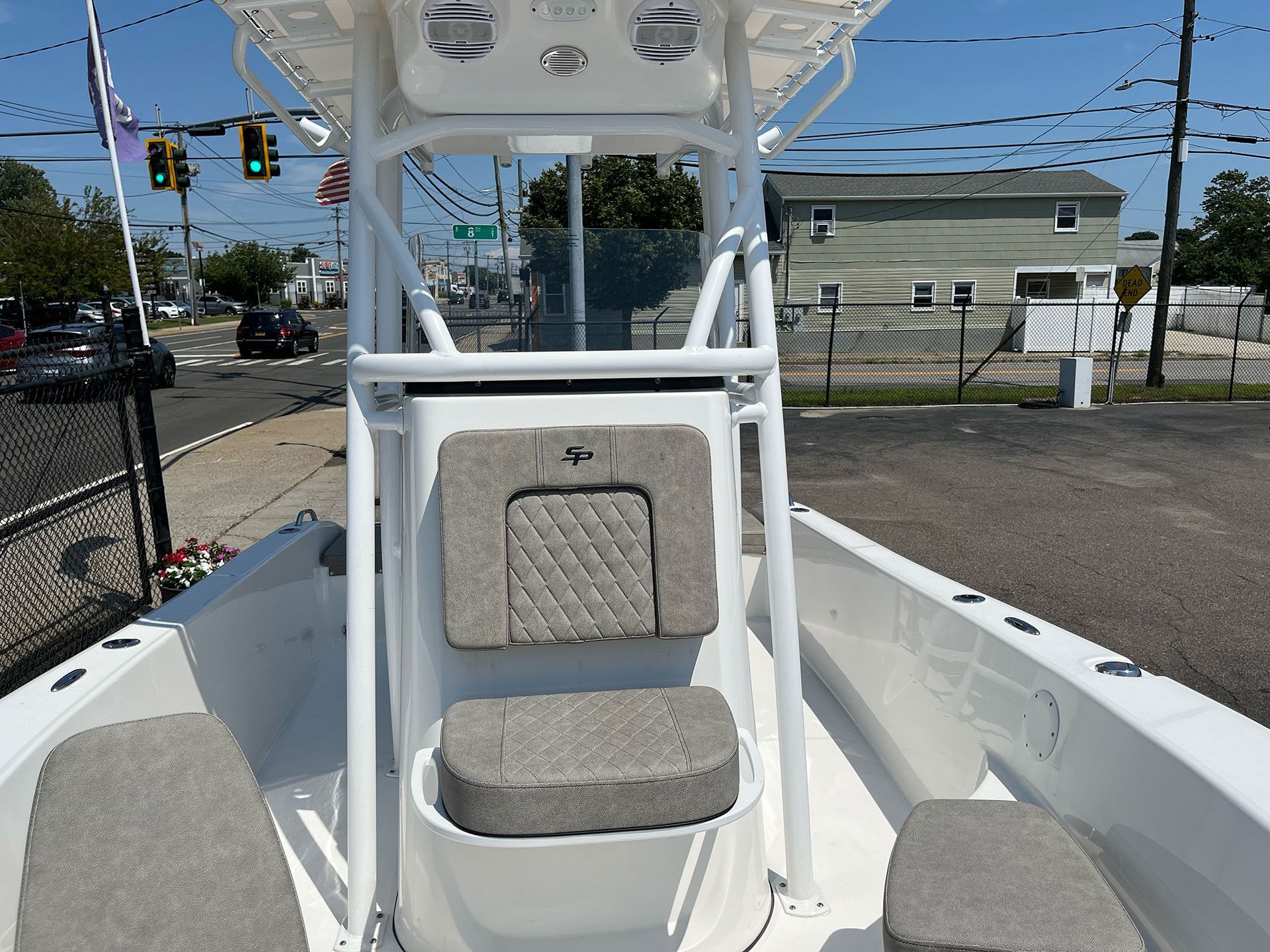 A white boat is parked on the side of the road