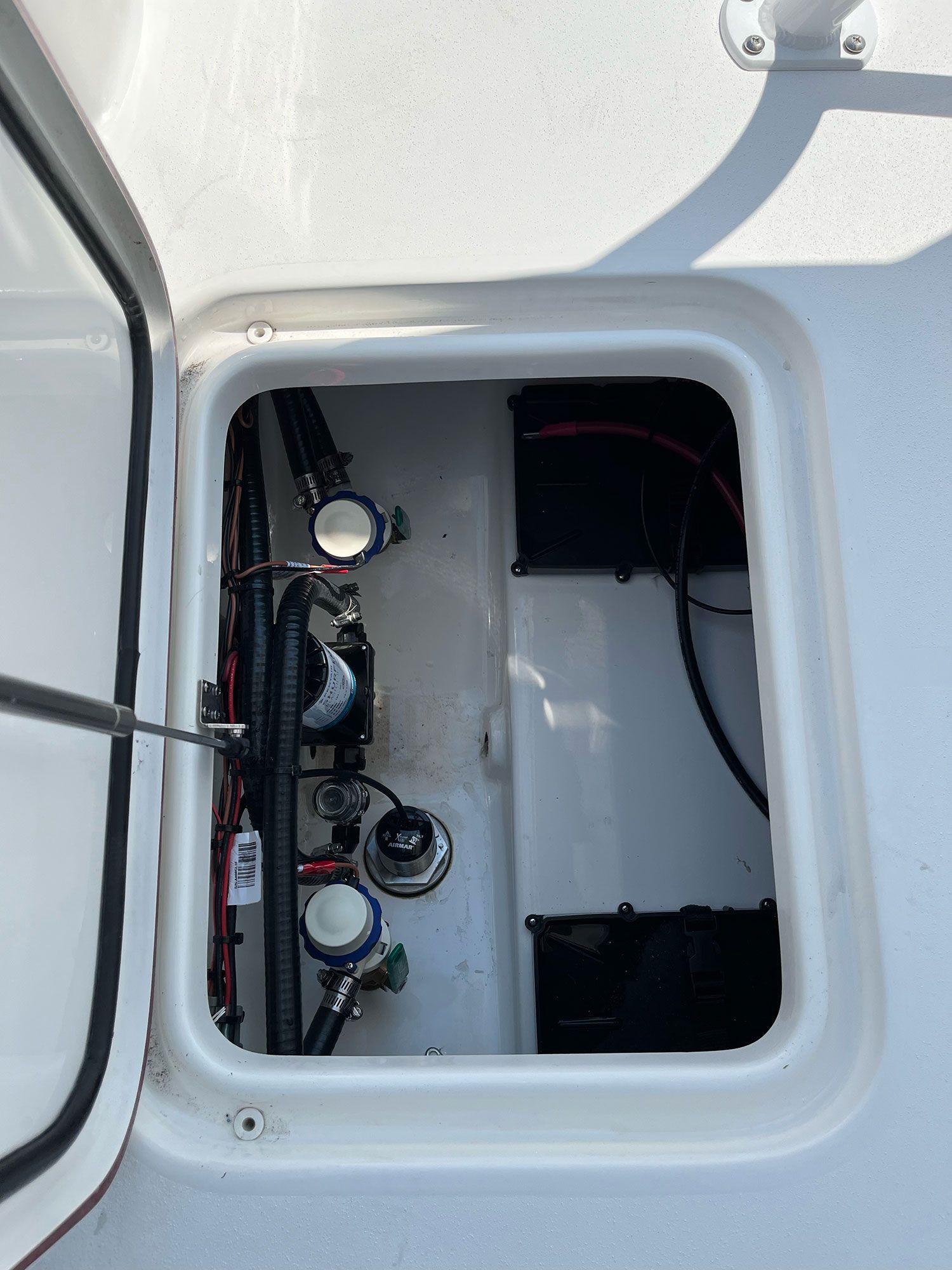 The engine compartment of a boat with the door open