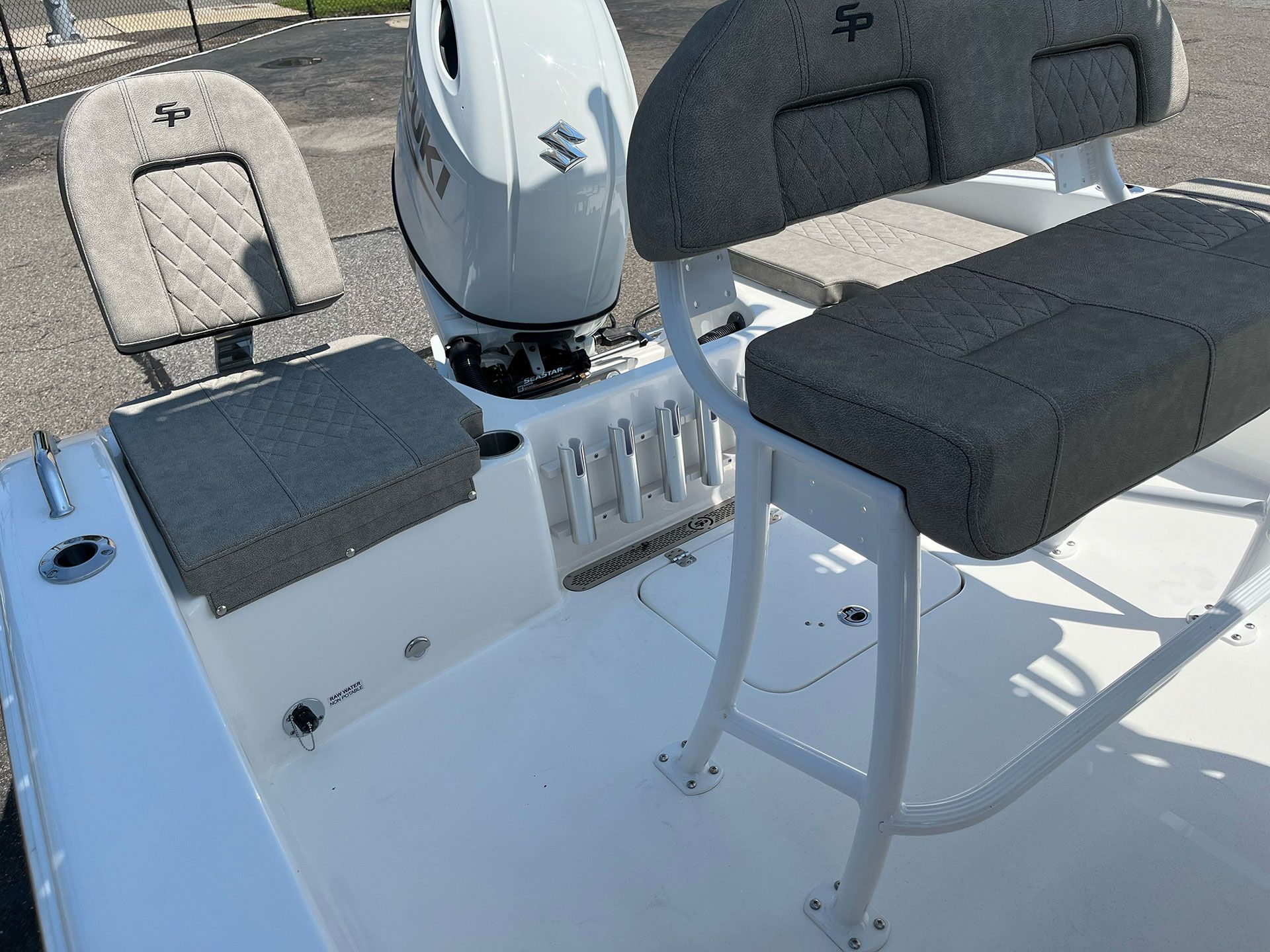 A boat with two seats and a motor on the back of it.