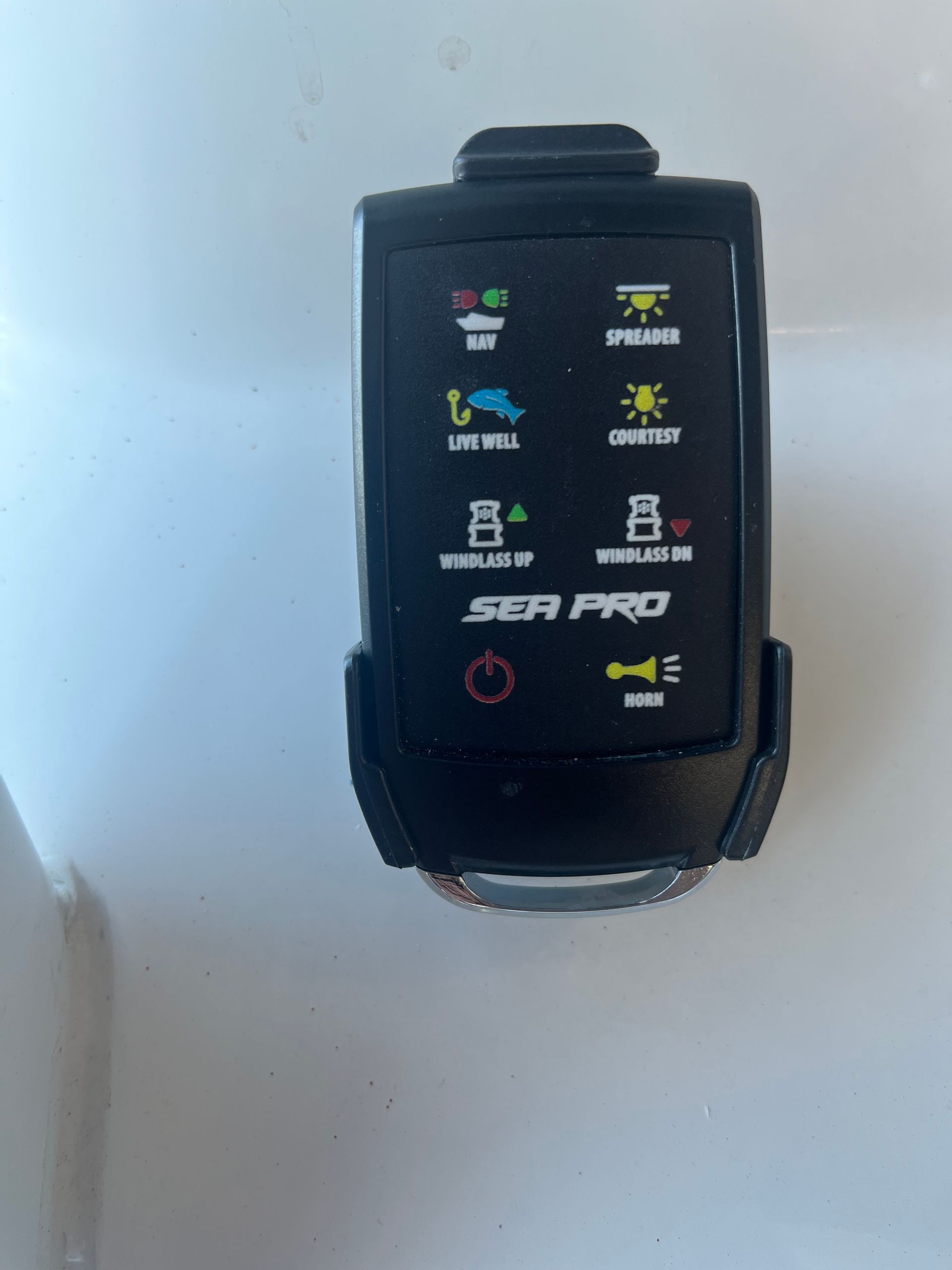 A sea pro remote control is sitting on a white surface