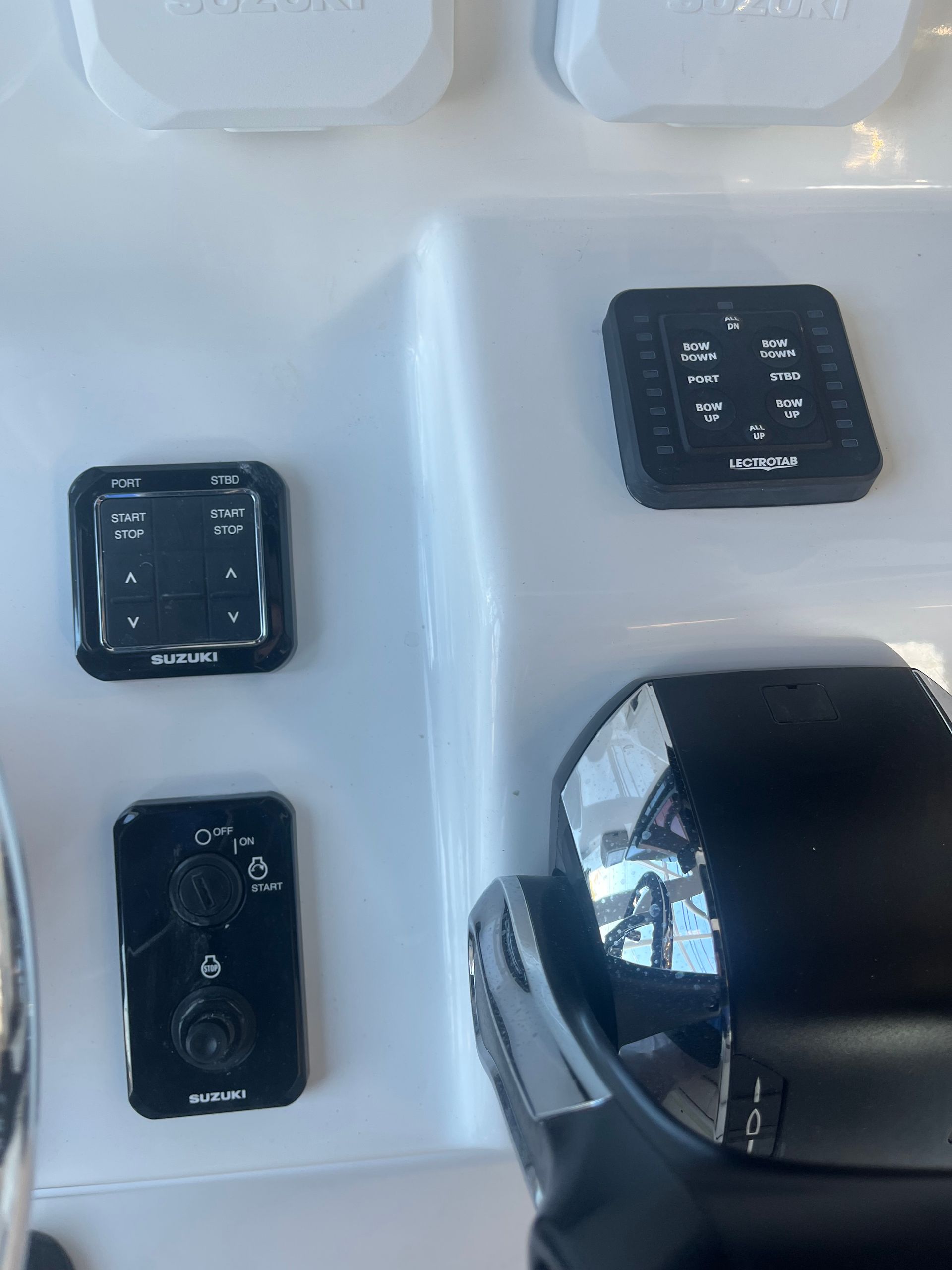 A close up of a boat 's control panel with a remote control
