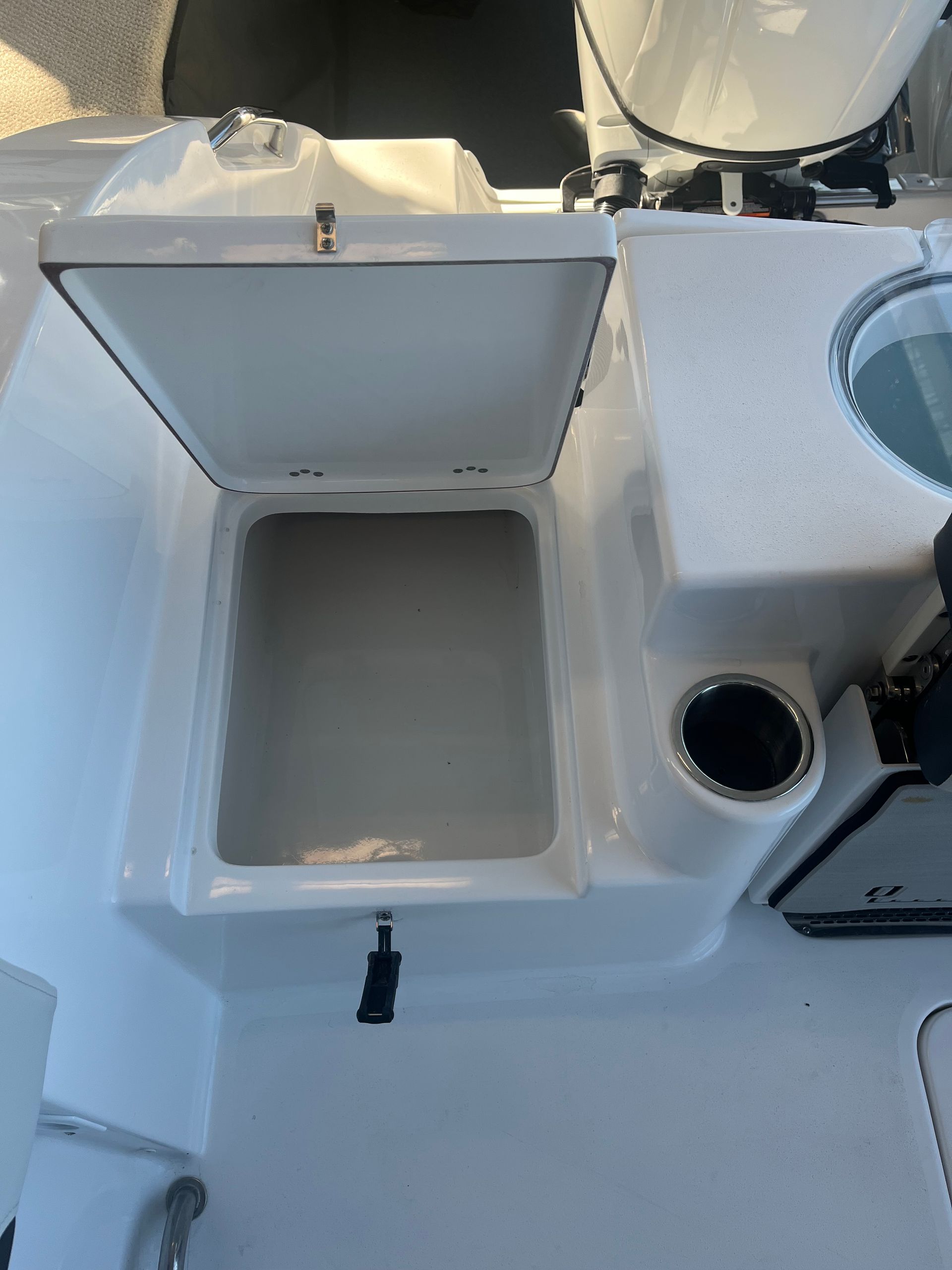 A boat with the lid open and a cooler inside of it