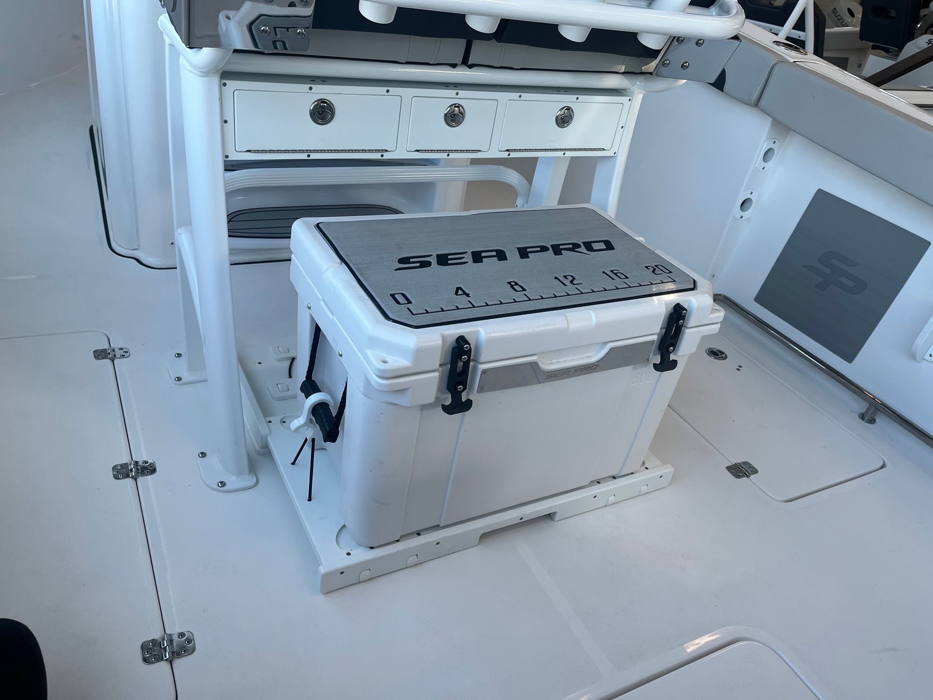 A white cooler is sitting on the deck of a boat