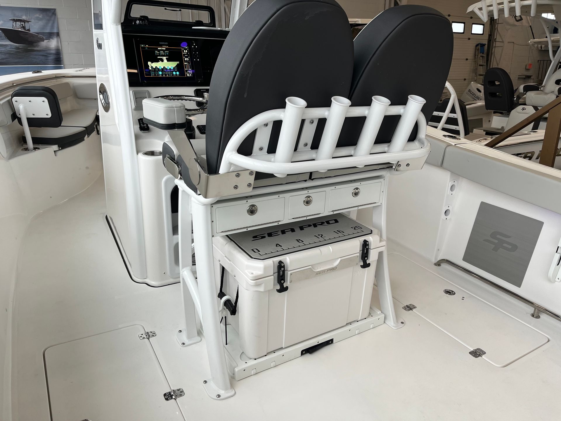 A boat with two seats and a cooler on the deck.