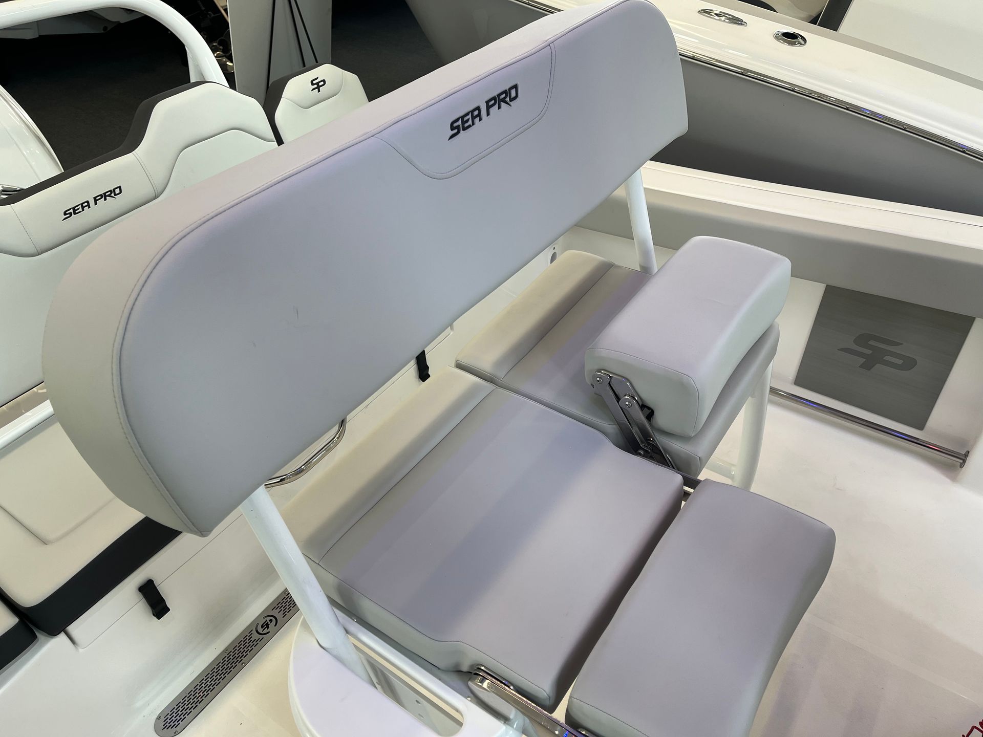 A white boat with a gray seat and arm rests